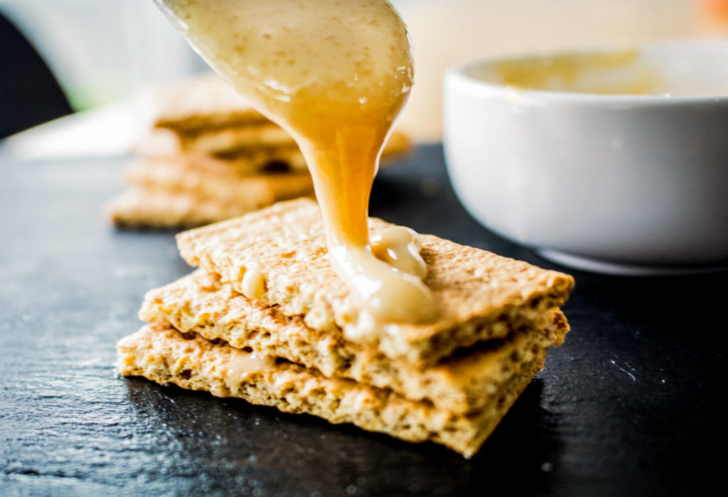 Photo of creamed honey on a biscuit.